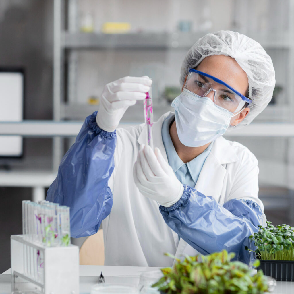 front view researcher with test tube plant biotechnology laboratory
